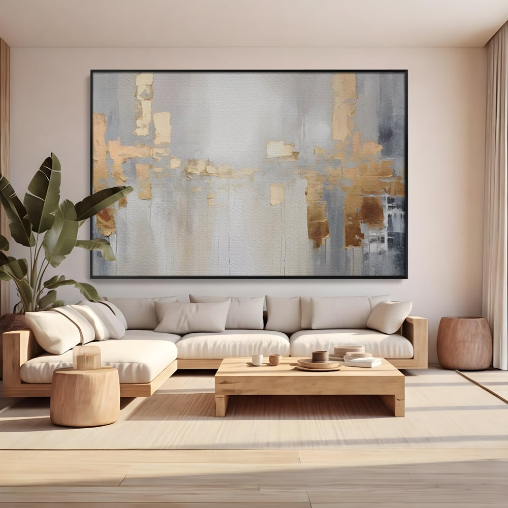 Tablou canvas cu pictura abstracta cu pete aurii si gri, in rama de aluminiu negru, pe perete intr-un living